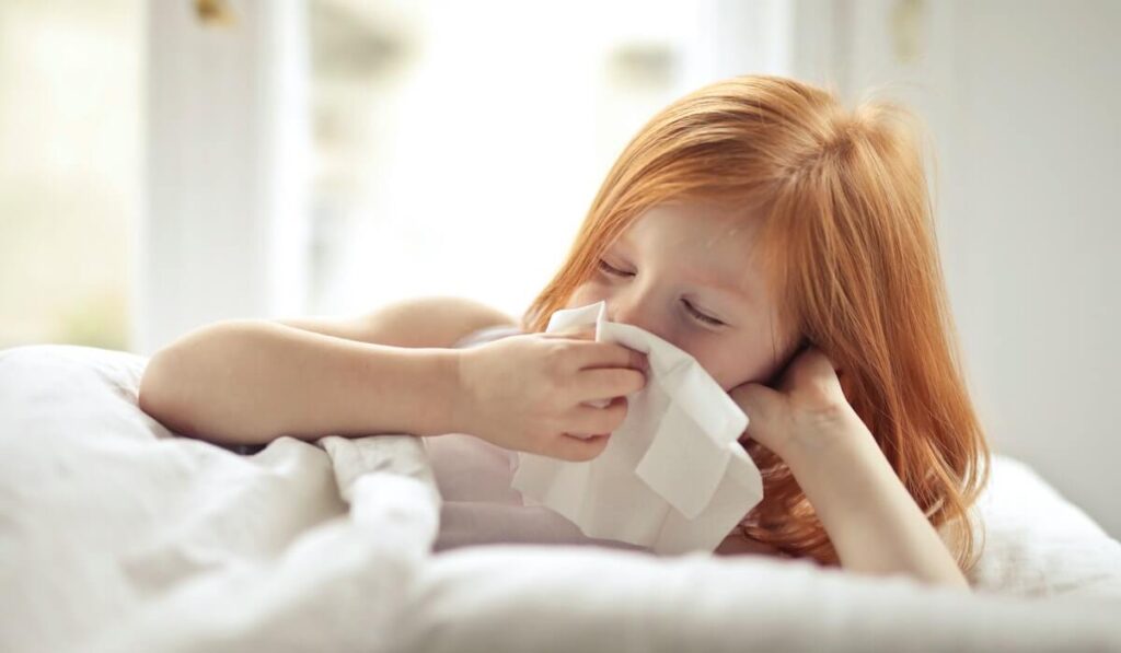 Girl Using Tissue to Blow Nose