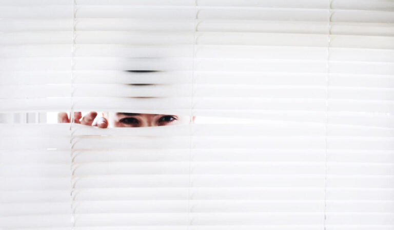 Eyes peeking out through the blinds